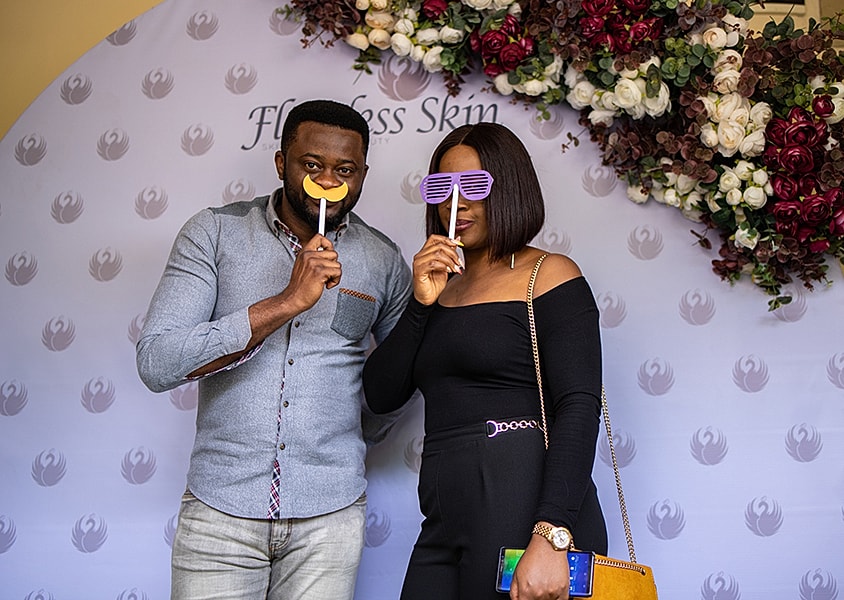 Couple posing with fun props at an event.