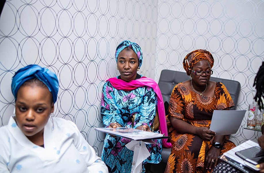 Women in traditional attire engaging in discussion.
