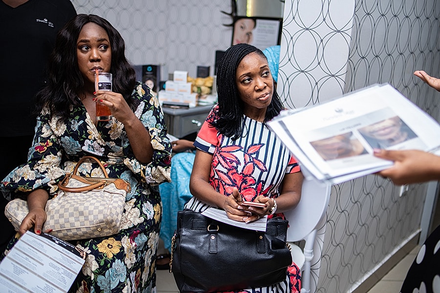 Women discussing beauty treatments in a salon.