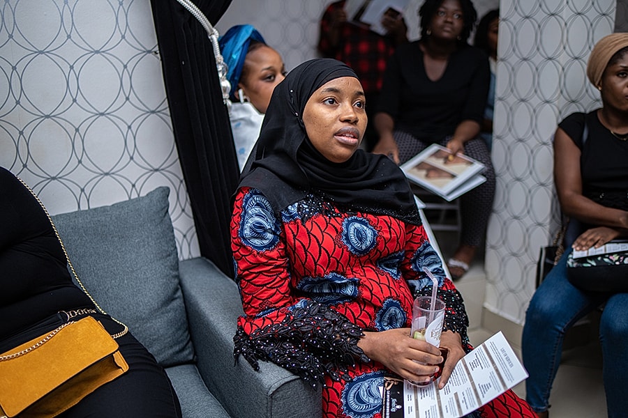 Woman in traditional dress attending an event.