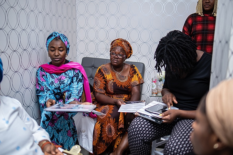 Women discussing in a modern waiting area.
