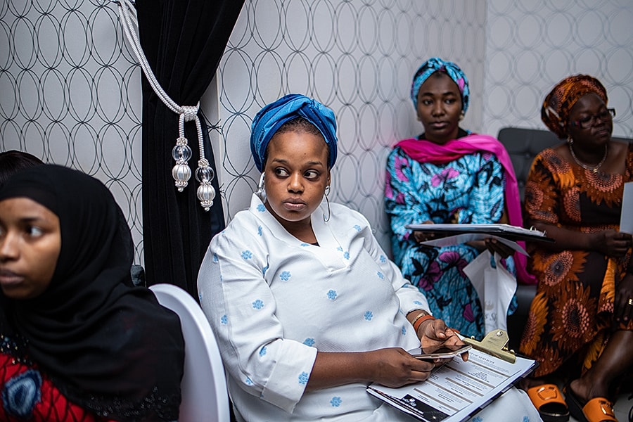 Women engaged in discussion in a meeting.