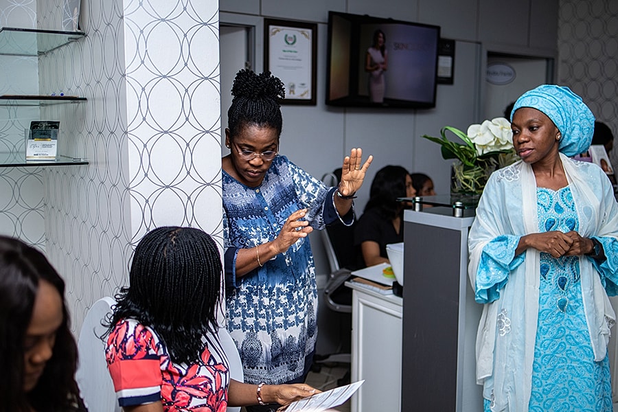 Women engaging in conversation at a professional setting.