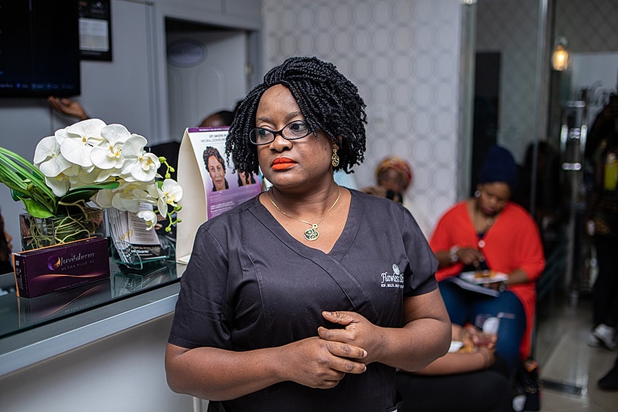 Woman with glasses in beauty salon setting.