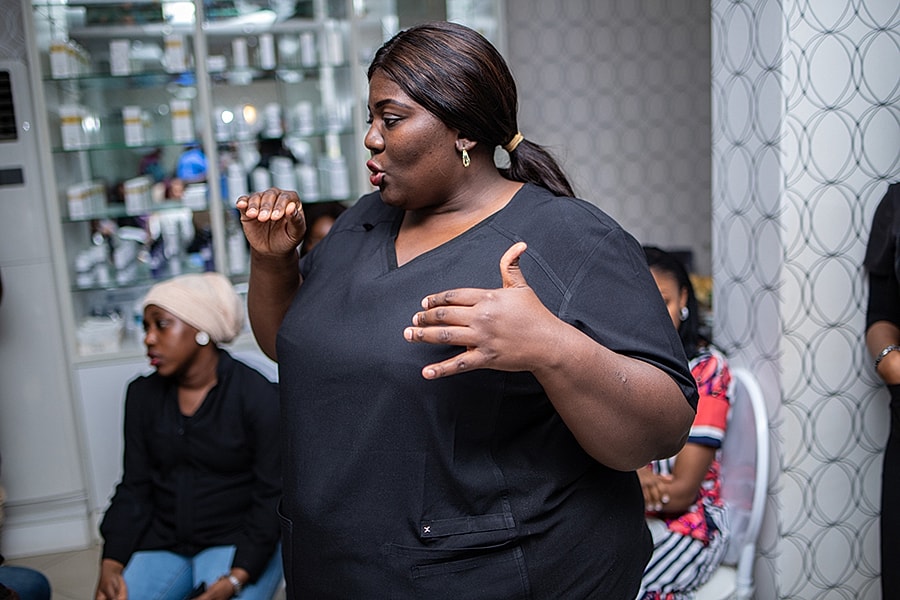 Woman speaking to a group in a clinic.