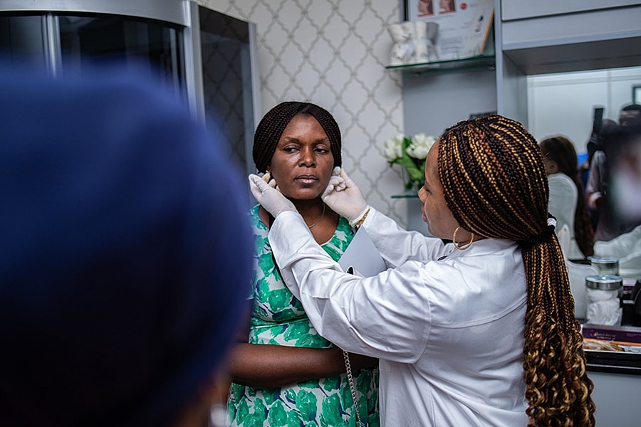 Client receiving skincare treatment in consultation room.