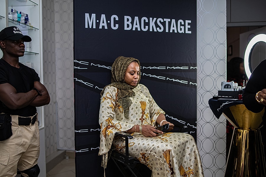 Woman in hijab at MAC backstage event.