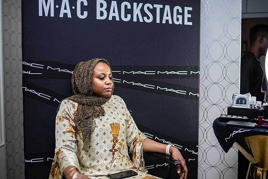 Person backstage at MAC makeup event.