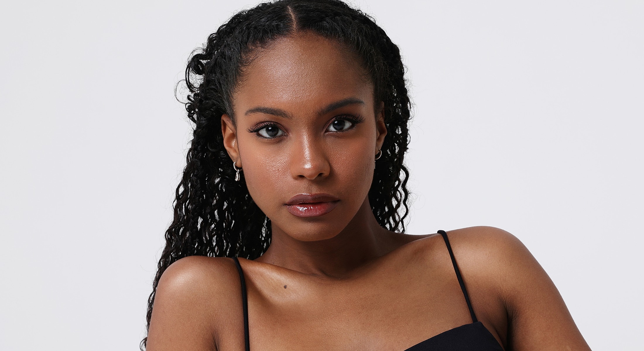 Abuja Facelift model with curly hair.