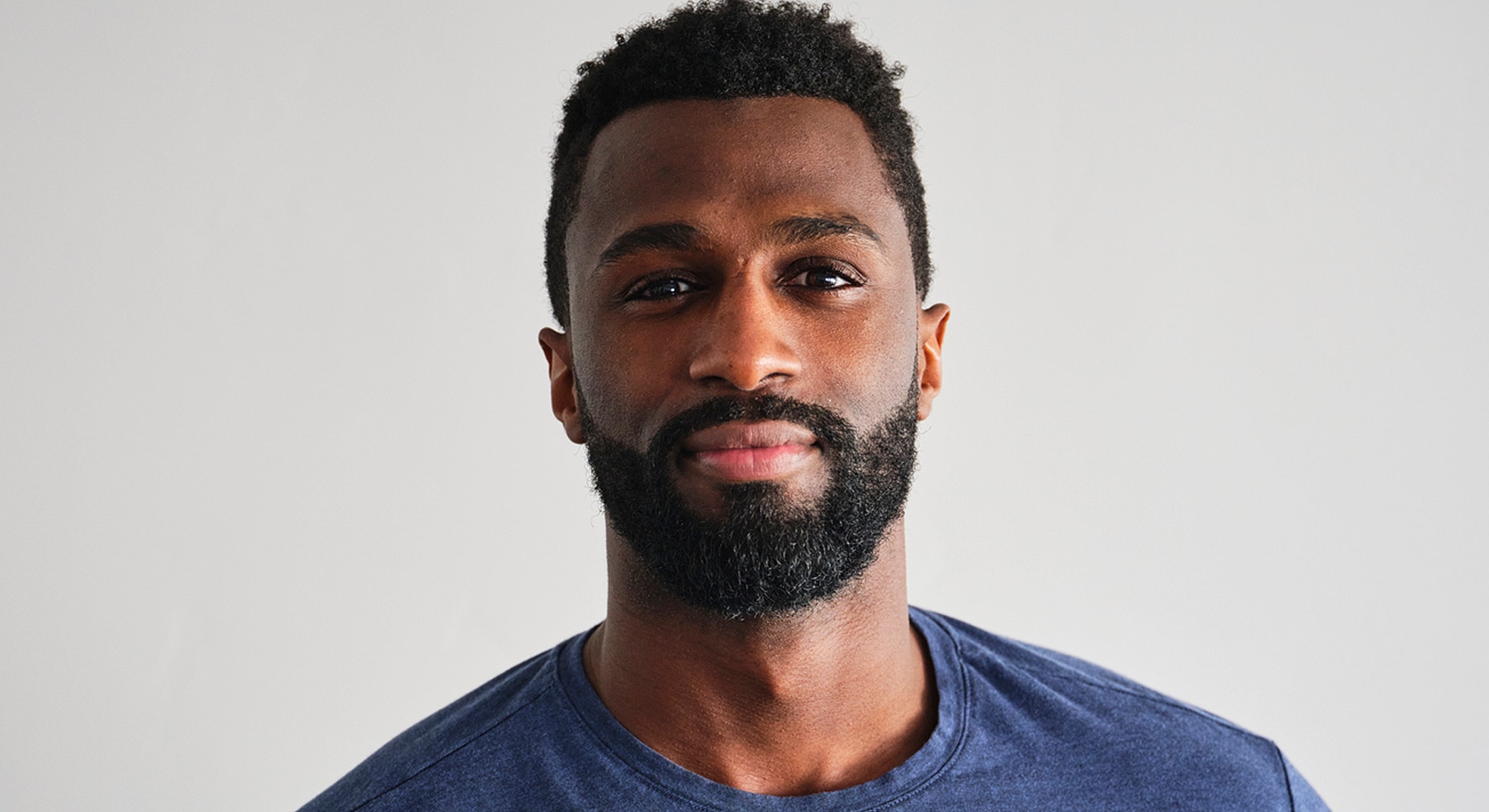 Abuja PRP Hair Restoration model with beard wearing a blue shirt.