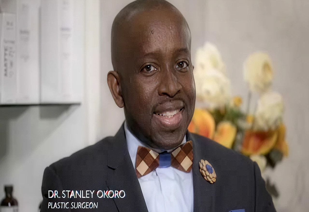 Man in suit with bow tie, smiling professionally.