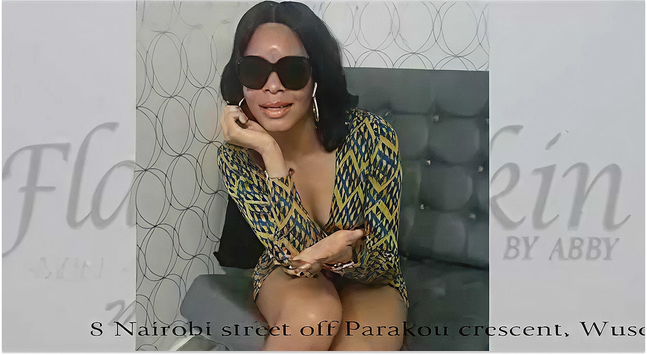 Woman in stylish outfit posing on a couch.