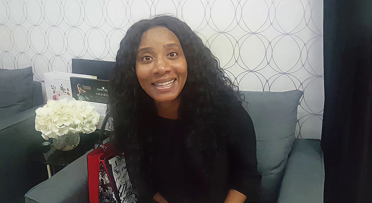 Woman smiling in a cozy indoor setting.