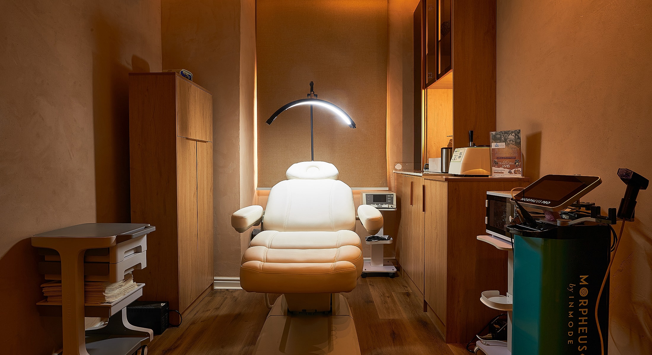 Treatment room with medical chair and equipment.