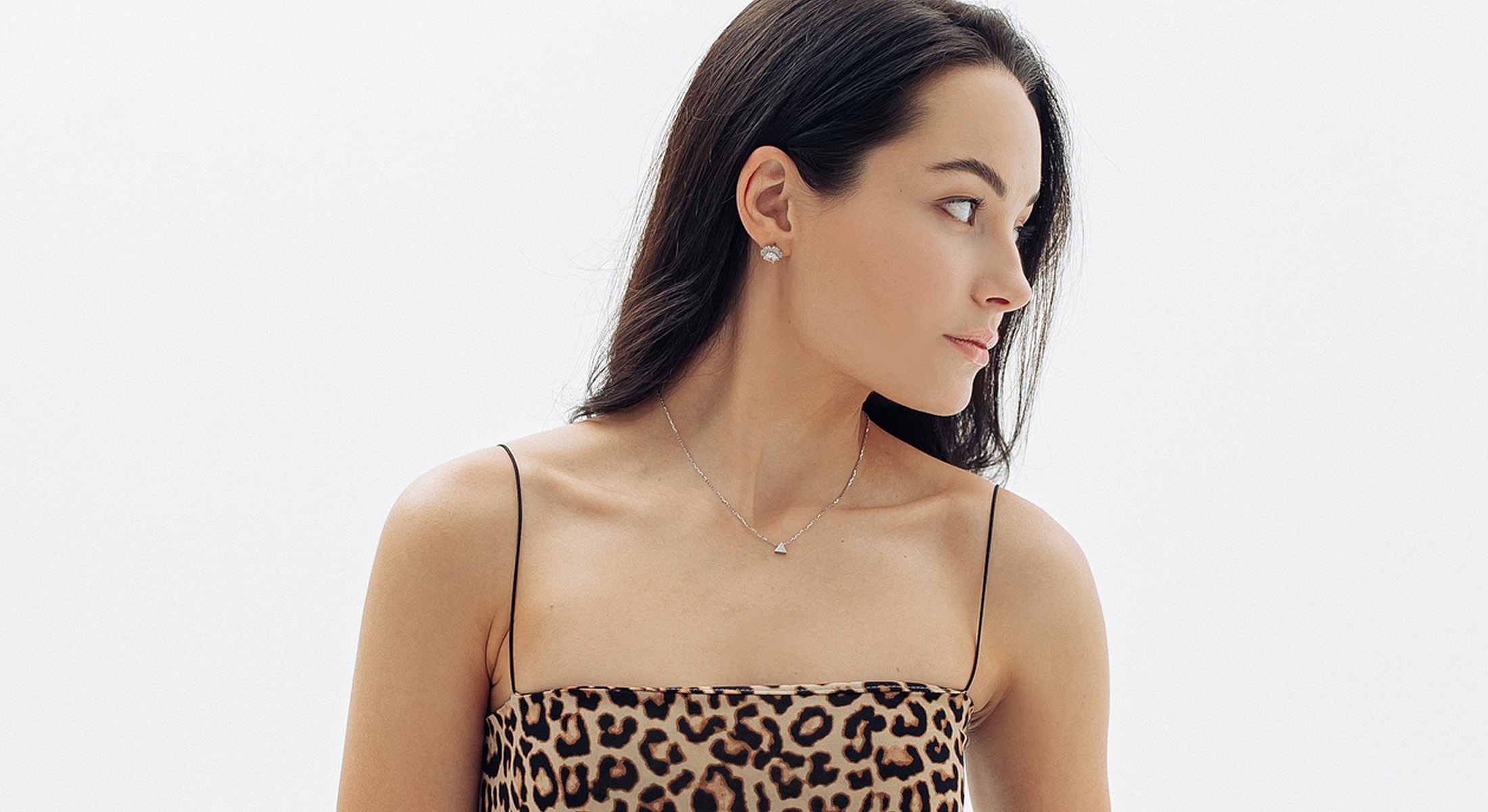 Abuja Morpheus8 Model wearing leopard print top and jewelry.